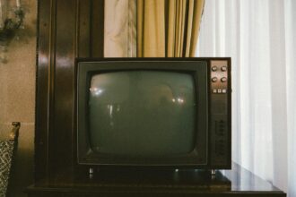 turned-off gray CRT TV on table